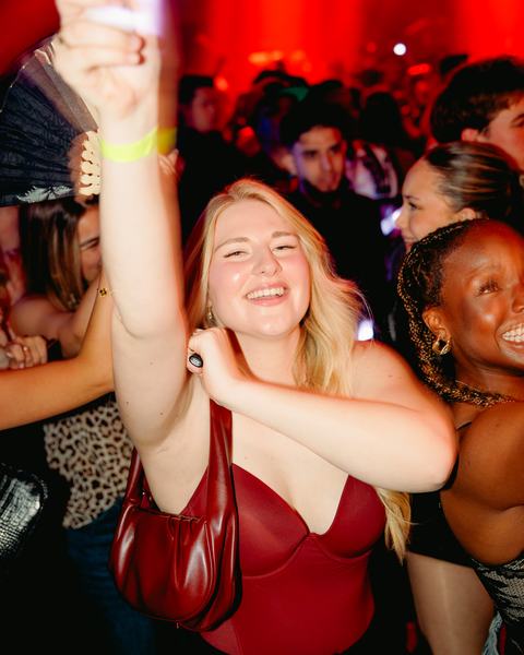 A smiling guest in red light, 16 May 2026