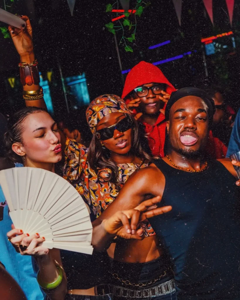 AFROTON guests dancing, one of them with a hand fan
